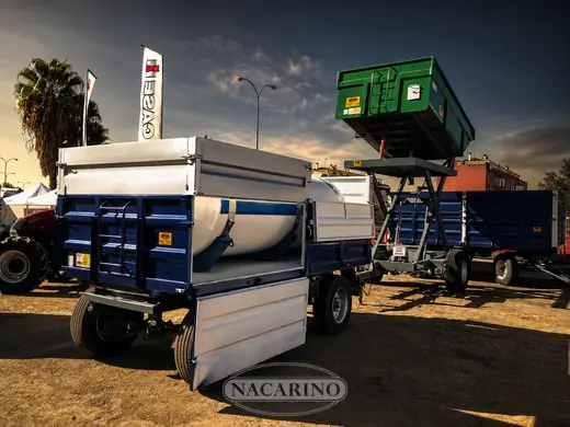 Remolque azul con cisterna cargada, en una feria agrícola